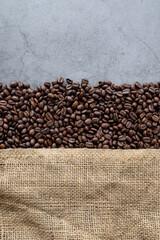 coffee bean and sack on old cement background. top view. space for text. flat lay