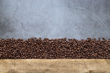 coffee bean and sack on old cement background. top view. space for text. flat lay