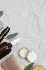 Natural organic skin care product. Home spa and self care concept. Facial serums, creams, jade roller and soap bars with copy space.