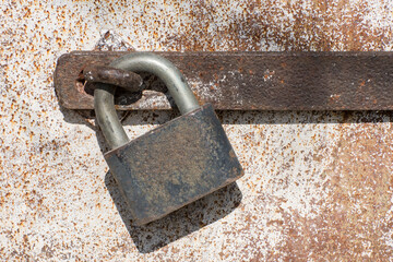 Large padlock on an old iron door. Home protection. Safety and prohibition symbol.