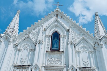 Basilica of Our Lady of Good Health, Sanctuary of St. Mary's shrine, Cathedral of St. Mary, facade of holy trinity. Roman Catholic Latin church tower against blue sky background in Velankanni.