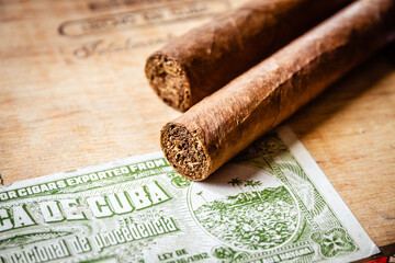 Cigars on vintage wooden box with Cuban official tax sticker