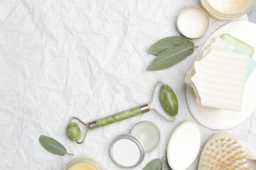 Natural organic skin care product. Home spa and self care concept. Facial serums, creams, jade roller and soap bars with copy space.