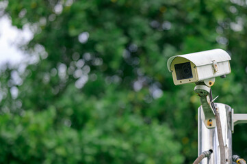 IP CCTV camera or surveillance security camera with nature bokeh background