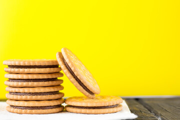 Chocolate filled sandwich biscuits on a yellow background