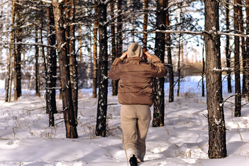 person walking in winter forest