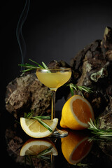 Traditional homemade lemon liqueur limoncello on the black background.