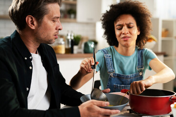 Loving couple eating lunch together at home. Husband and wife enjoying in tasty meal.