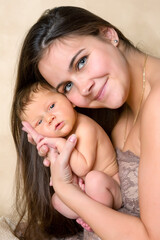 Smiling mother with newborn baby