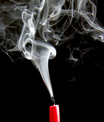 wisp of smoke from an extinguished candle