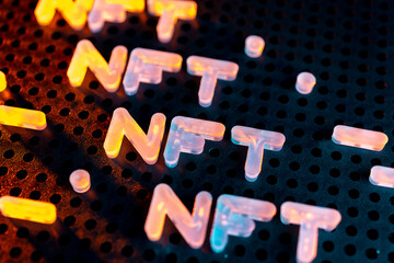 NFT nonfungible tokens text from letters glowing with neon light on a dark background