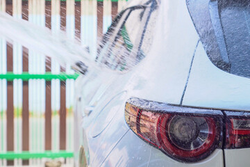 Wash the car with clean water from the hose. Water saving concept.