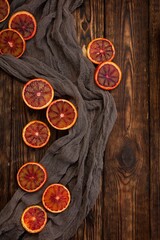 Obraz na płótnie Canvas Slices of red oranges on a dark wooden background. Rustic style