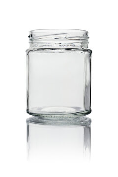 Empty glass jar without a lid. Close-up, isolated on a white background with reflection.