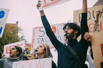 Male and female activist participating in anti-racism protest