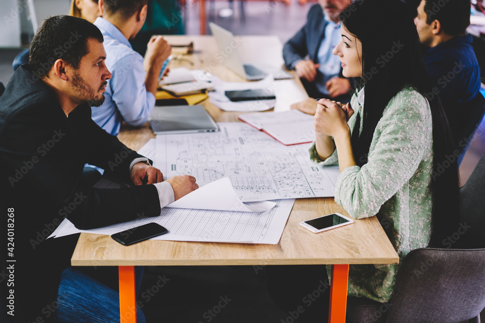 Poster male and female designers dressed in formal wear collaborating on sketches in office, professional a