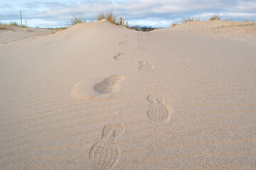 Footprints in the sand at South Shields beach, a seaside town near Newcastle upon Tyne in the North East of England.
