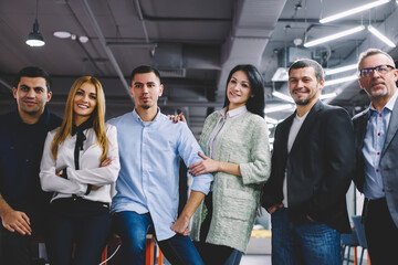 Obraz premium Half length portrait of successful male and female colleagues looking at camera during collaborative meeting for building competitive team, smart casual corporate directors posing during time on job