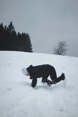 Athlete falls from a plastic snowboard and falls hard on the snow and sprawls. The boy's board got...