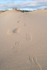 Footprints in the sand at South Shields beach, a seaside town near Newcastle upon Tyne in the North East of England.