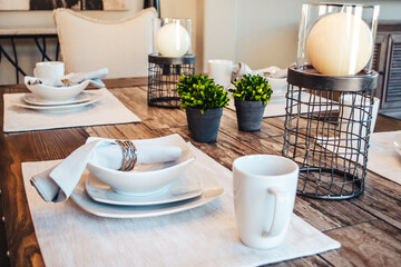 Kitchen interior design photos, place setting on the table. Light, bright modern homes living in luxury and style. Colors of white, blue, neutral - clean lines. Real estate photos.