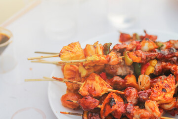 Blurred image,Barbecue (BBQ) skewered on a charcoal grill is a street food that is convenient for a party or picnic and barbecue (BBQ) is also increasing its popularity in many countries.