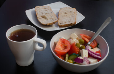 Greek breakfast with salad, bread and tea