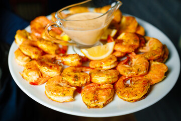 King prawns in a creamy sauce on a dish. 