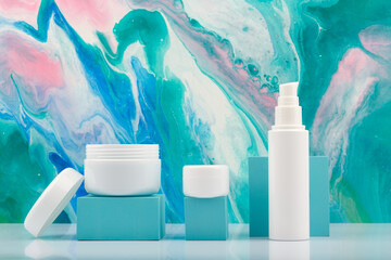 Opened cream jar and set of cosmetic creams for face, neck and under eye area on white table...