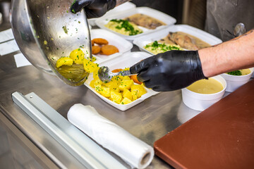 Chef preparing takeaway dish in the restaurant or pub , food delivery concept, home delivery, online order