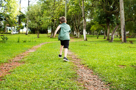 Garoto correndo no campo - Powered by Adobe