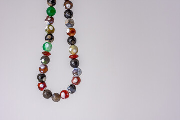 Close up colorful men's Muslim Prayer beads hanging on white background, Ramadan concept 