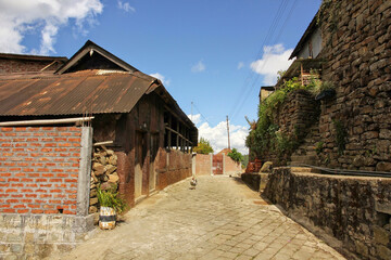 Fototapeta na wymiar An alley lined with old houses in the village of Khonoma in Nagaland