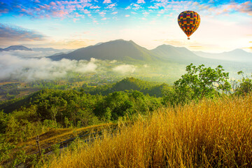 Colorful hot-air balloons flying over the mountain,Doi Inthanon National park in the sunrise and...