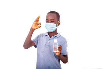 little boy with a medical mask holding an antibacterial gel.