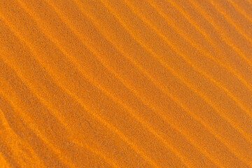 Rippled golden brown desert sand Texture background