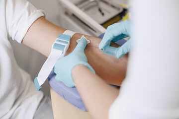 Nurse taking blood sample from patient at the doctors office