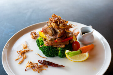 Roasted duck with seasoning sauce and vegetable on plate