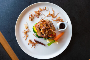 Roasted duck with seasoning sauce and vegetable on plate
