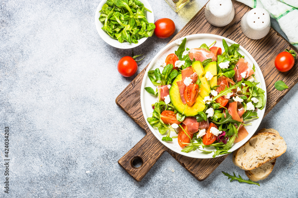 Canvas Prints Fresh salad with green leaves, jamon and tomatoes.