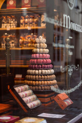 Muesli with yougurt and fresh berries in black bowl on dark gray background.