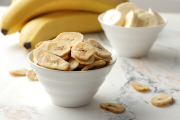 Composition with sweet banana slices   , top view with space for text. Dried fruit as healthy snack. Healthy breakfast