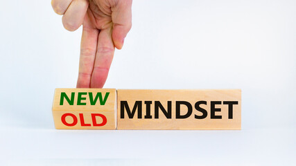 New vs old mindset symbol. Businessman turns the wooden block and changes words 'old mindset' to 'new mindset'. Beautiful white background. Business, new or old mindset concept. Copy space.