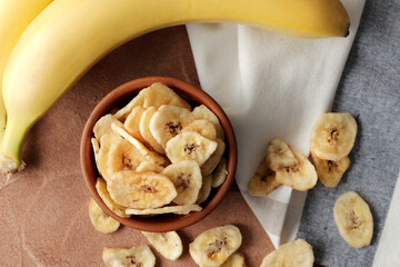 Composition with sweet dried banana slices, fresh bananas. Top view with space for text. Dried fruit as healthy snack. Healthy breakfast