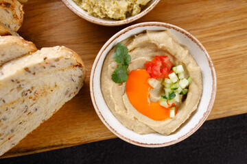 A bowl of creamy hummus with fresh vegetables
