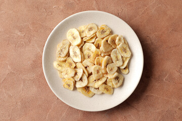 Heap of sweet banana slices on  a  background. Dried fruit as healthy snack