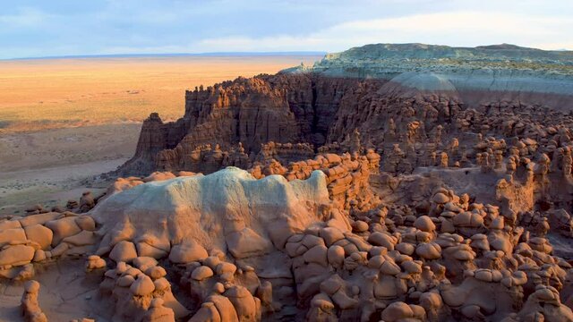 Sunset over rock formations in Goblin Valley desert, aerial