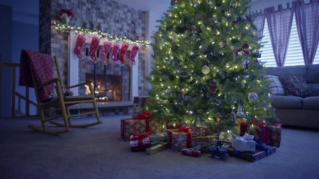 Medium shot, presents around Christmas near fireplace in living room