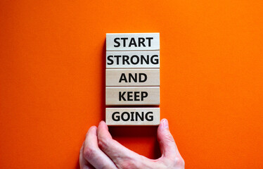 Start strong and keep going symbol. Concept words 'Start strong and keep going' on wooden blocks on...