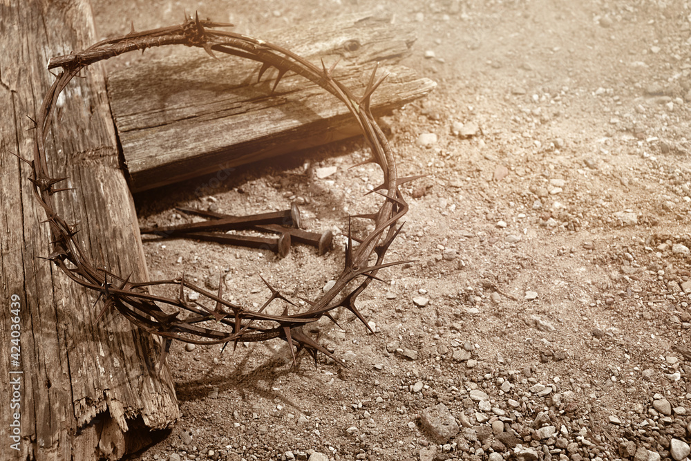 Wall mural crucifixion of jesus christ. cross with three nails and crown of thorns on ground.